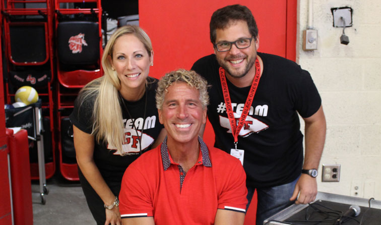 three faculty members smiling in red and black shirts