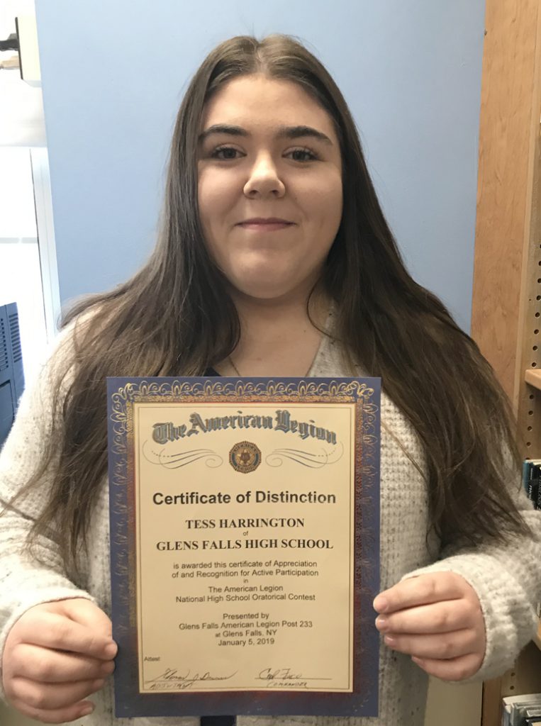 girl smiling holding certificate