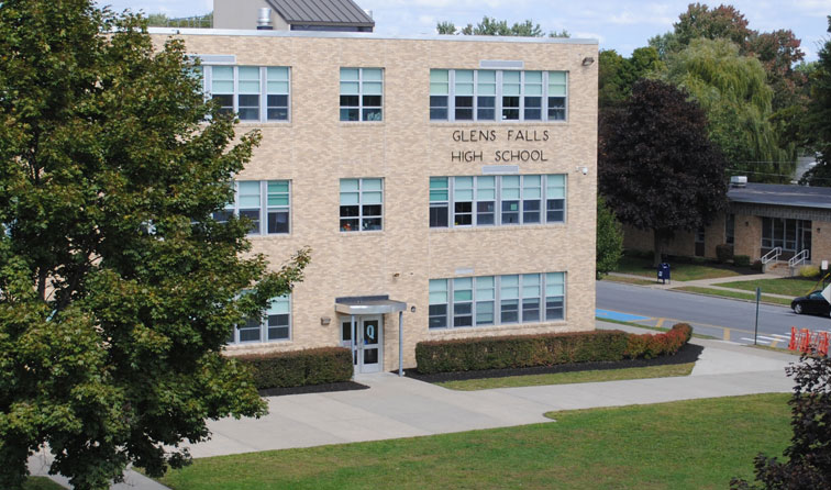 exterior building of Glens Falls High School with green grass and tree