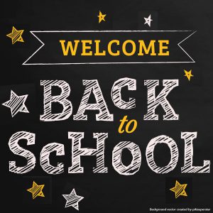 white chalk letters on a black background that read welcome back to school, with stars drawn around it