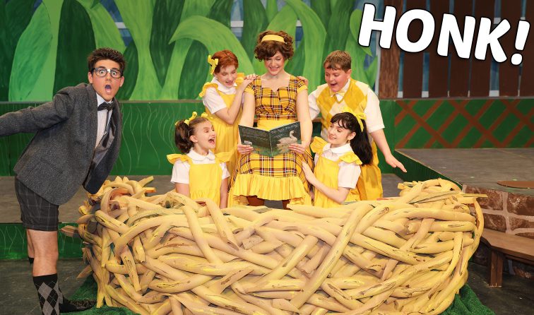 Six students in costumes on stage during a scene from HONK the musical