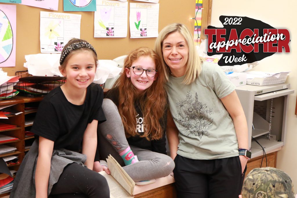 teacher with two students smiling and teacher appreciation week logo