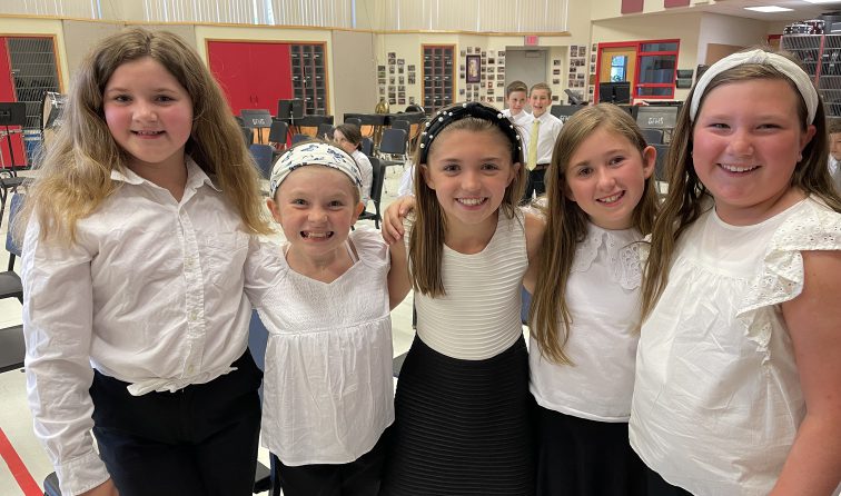 group of students smiling before their school concert