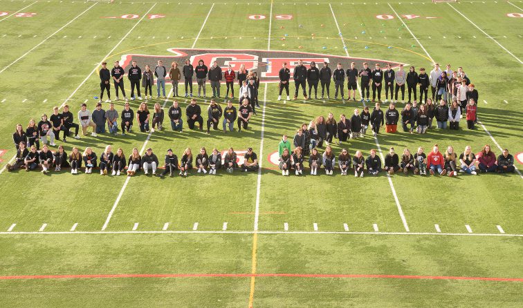 students in the shape of the number 22 on the football field