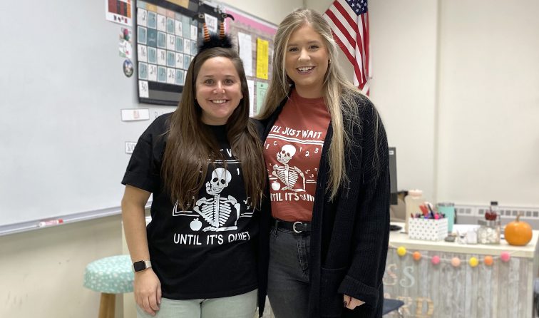 two teachers wearing really funny shirts of a skeleton at a chalkboard having "just waited until it's quiet" and expired waiting