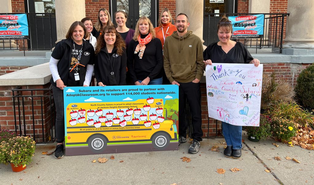 group of teacher holding thank you sign for Subaru donation at elementary school