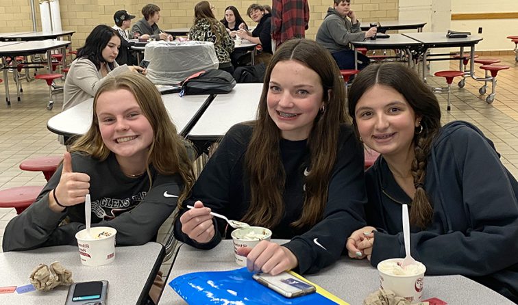 students in the high school cafeteria enjoying ice cream sundaes for being VIPs