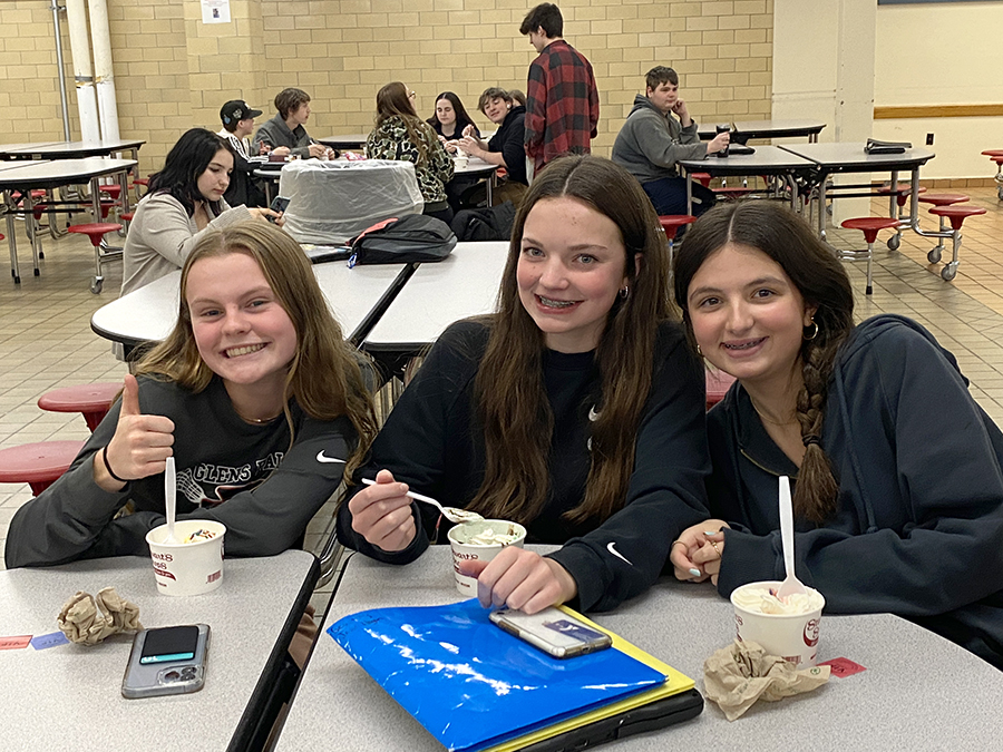 students in the high school cafeteria enjoying ice cream sundaes for being VIPs