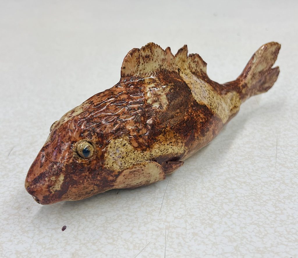 realistic sculpture of a fish with beautiful brown coloring and glassy eyes created by student-artist Rohan M.