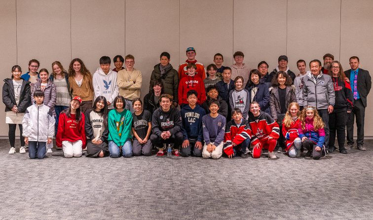 group of exchange students and hosts pose for a group picture while getting to meet Adirondack Thunder player Yushiroh Hirano